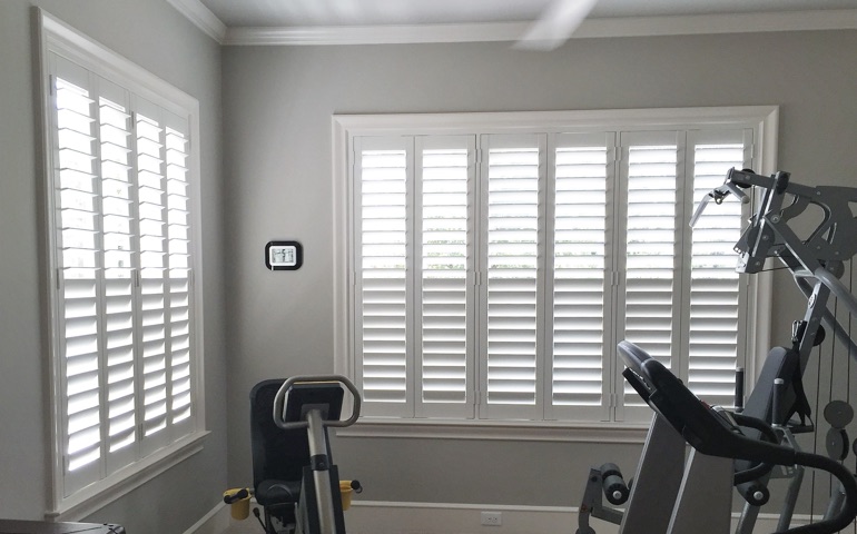 San Antonio home gym with shuttered windows.